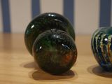 three glass vases sitting on a table next to each other