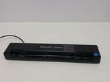 a close up of a black electronic device on a white surface