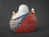 a white and red vase sitting on top of a table