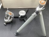 a metal tripod with a metal handle on a black table