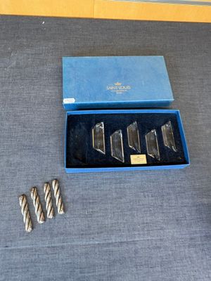 five pieces of silver in a blue box on a table