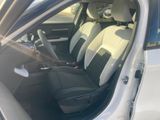 the interior of a car with the door open showing the front seats