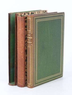 three books are stacked on top of each other on a white surface