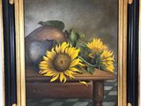 une peinture à l'huile représentant des tournesols et un vase posés sur une table