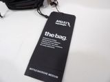 a black bag with a tag on it sitting on a table