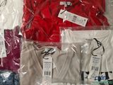 a lot of t - shirts that are wrapped in plastic