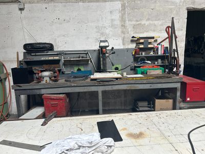 an image of a workbench in a garage with a lot of tools