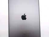 an apple ipad sitting on top of a white table next to a white wall