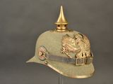 a green hat with a gold eagle on it