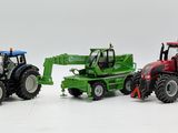 three toy tractors that are sitting next to each other