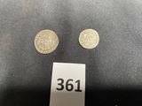 a close up of two coins on a table with a price tag