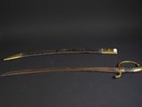 a pair of swords with brass handles on a black background