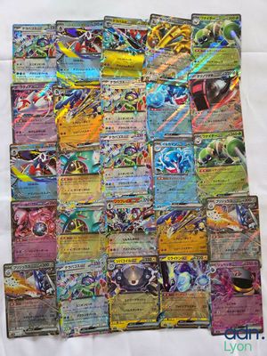 a pile of pokemon cards sitting on top of a table