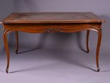 an old wooden table with a marble top on a grey background