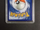 a pokemon card in a plastic holder on a table
