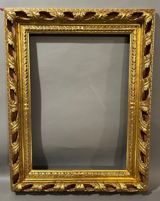 a gold frame with leaves and scrolls on it