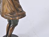 bronze figurine of a boy holding a baseball bat on a black base