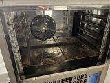 a silver oven with a fan inside of it
