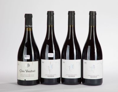 three bottles of red wine are lined up on a white surface