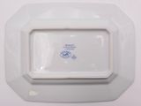 a white plate with a blue and white design on it