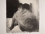 a black and white photo of a woman laying on a bed