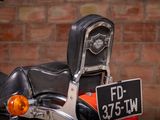 a motorcycle that is parked in front of a brick wall