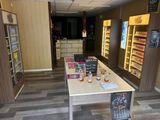 a long table with bottles of liquor on it in a store