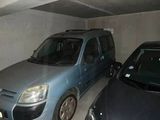 two cars parked in a parking garage next to each other