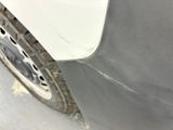 a close up of a car ' s front bumper and tire