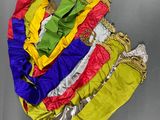 five different colored bags hanging on a metal wall