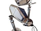 a picture of a desk lamp with a cell phone attached to it