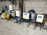 a lot of machines that are lined up in the garage