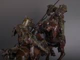 a statue of a man riding a horse with a spear