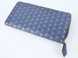 sac à main à motifs bleus et dorés, orné de pompons et d'un pompon