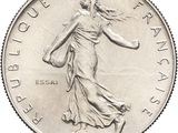 an image of a silver coin with a woman walking on it