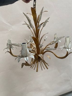 a person that is holding a chandelier in their hand