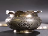 a silver vase sitting on top of a table