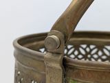 a small metal basket with a handle on it