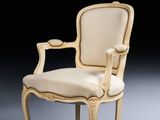 a white chair with a beige upholstered back and arms