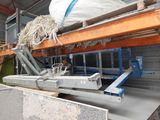 a picture of a machine that is working on a piece of concrete
