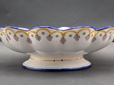 a white bowl with blue and yellow designs on it