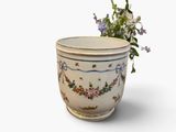 a vase with flowers in it on a white surface