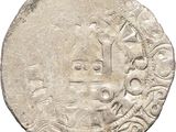 a close up of a silver coin with a design on it