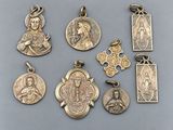 a group of religious pendants on a gray surface
