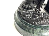 a statue of a dog sitting on a pedestal