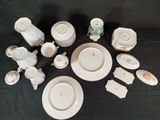 a lot of white plates and bowls on a table