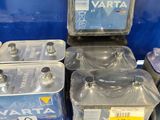 many plastic containers of water on the shelf in the store