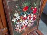 a picture of a painting of flowers on a wooden chair