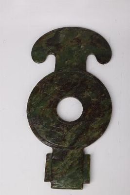 an image of a green metal object on a white surface