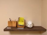 a wooden shelf with a mirror, toothbrushes, and other items on it